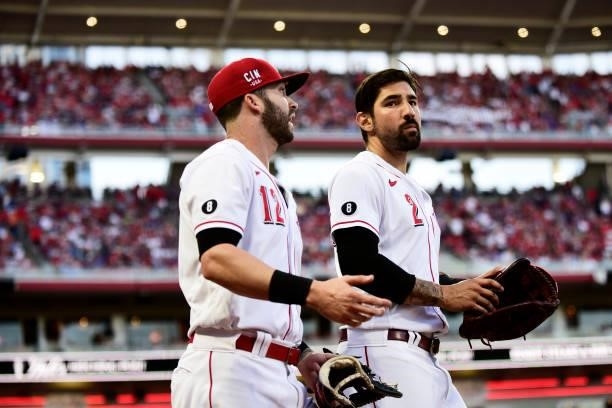 Nick Castellanos and Tyler Naquin of the Cincinnati Reds walk onto the field during a game between the Chicago Cubs and Cincinnati Reds at Great...