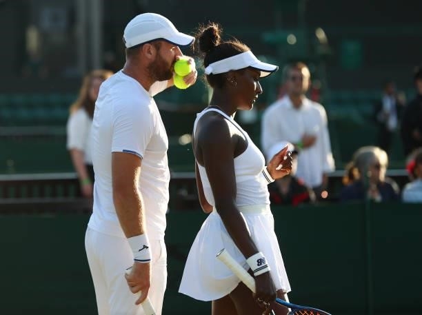 Luke Bambridge of Great Britain and Asia Muhammad of United States in action during their mixed doubles second round match against Neal Skupski of...