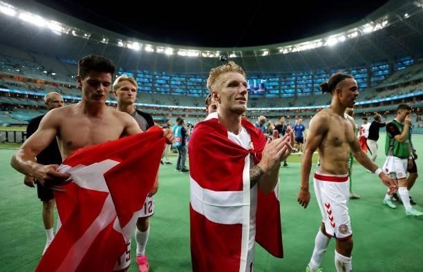 Christian Norgaard, Daniel Wass and Yussuf Poulsen of Denmark celebrate their side's victory after the UEFA Euro 2020 Championship Quarter-final...