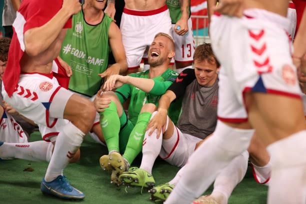 Kasper Schmeichel and Mikkel Damsgaard of Denmark celebrate with teammates after victory in the UEFA Euro 2020 Championship Quarter-final match...