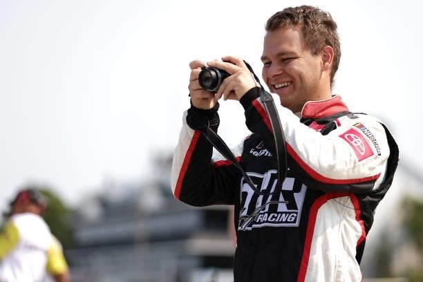 Kris Wright, driver of the Wright Automotive Toyota, takes a photo on the grid during the NASCAR Xfinity Series Henry 180 at Road America on July 03,...