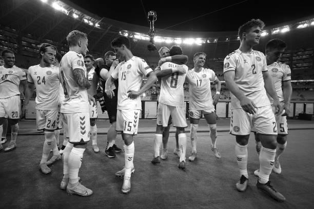 Kasper Schmeichel of Denmark hugs Thomas Delaney as they celebrate their side's victory after the UEFA Euro 2020 Championship Quarter-final match...