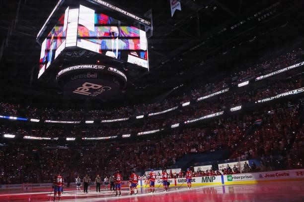 The Tampa Bay Lightning and the Montreal Canadiens stand at attention prior to Game Three of the 2021 NHL Stanley Cup Final at the Bell Centre on...