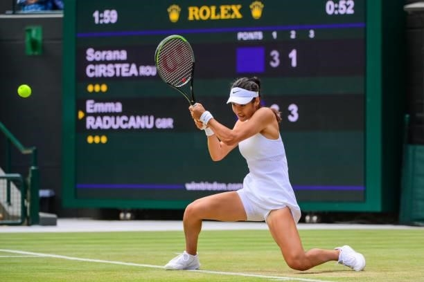 Emma Raducanu of Great Britain hits a backhand against Sorana Cirstea of Romania in the third round of the ladies singles during Day Six of The...