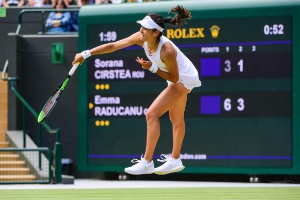 Emma Raducanu of Great Britain serves against Sorana Cirstea of Romania in the third round of the ladies singles during Day Six of The Championships...