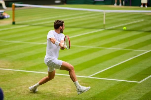 Cameron Norrie of Great Britain hits a backhand against Roger Federer of Switzerland in the third round of the gentlemen's singles during Day Six of...