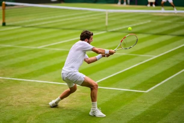 Cameron Norrie of Great Britain hits a backhand against Roger Federer of Switzerland in the third round of the gentlemen's singles during Day Six of...