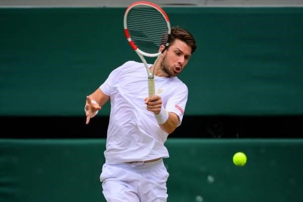 Cameron Norrie of Great Britain hits a forehand against Roger Federer of Switzerland in the third round of the gentlemen's singles during Day Six of...