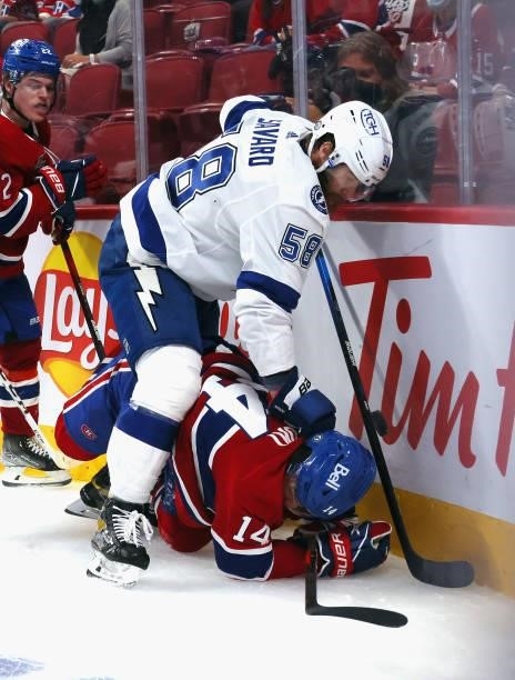 David Savard of the Tampa Bay Lightning checks Nick Suzuki of the Montreal Canadiens during Game Three of the 2021 NHL Stanley Cup Final at the Bell...