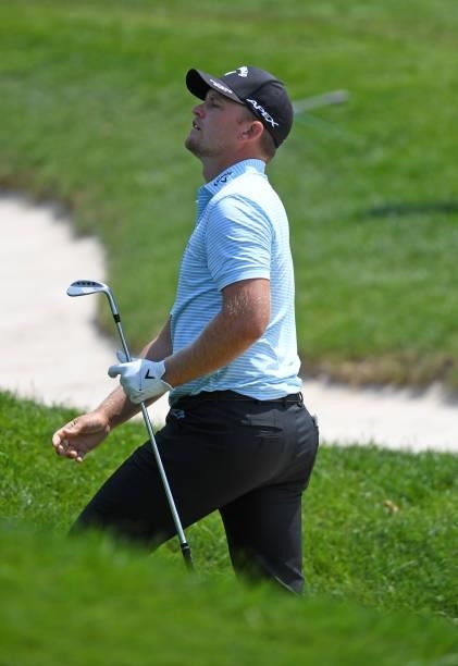 Tom Lewis of England reacts to his chip onto the fifth hole during the third round of the Rocket Mortgage Classic on July 03, 2021 at the Detroit...