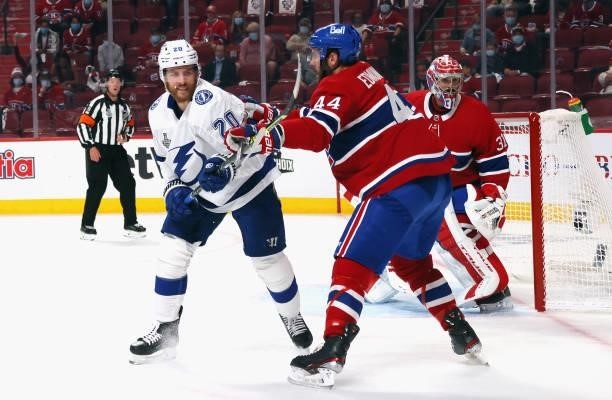 Blake Coleman of the Tampa Bay Lightning is checked by Joel Edmundson of the Montreal Canadiens during Game Three of the 2021 NHL Stanley Cup Final...