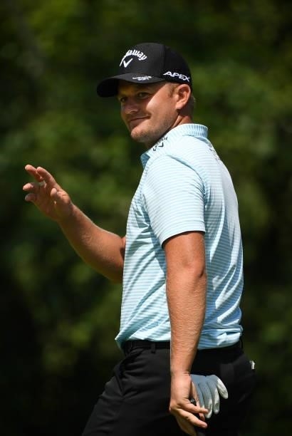 Tom Lewis of England reacts to his putt on the eighth hole during the third round of the Rocket Mortgage Classic on July 03, 2021 at the Detroit Golf...