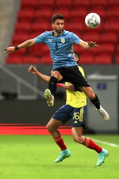 Rodrigo Bentancur of Uruguay jumps against Mateus Uribe of Colombia during a quarter-final match of Copa America Brazil 2021 between Colombia and...