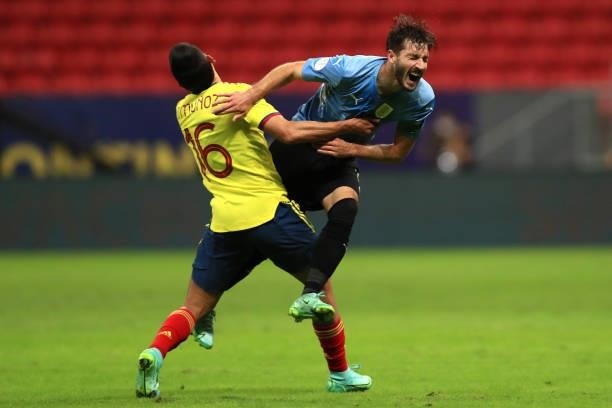 Matias Viña of Uruguay collides against Daniel Muñoz of Colombia during a quarter-final match of Copa America Brazil 2021 between Colombia and...