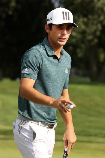 Joaquin Niemann of Chile reacts to his birdie putt on the 17th hole during the third round of the Rocket Mortgage Classic on July 03, 2021 at the...