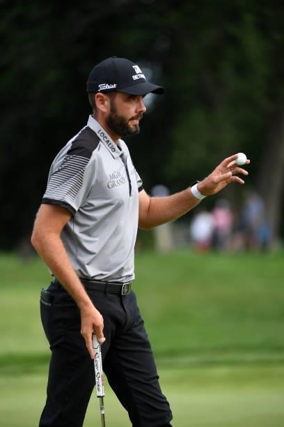 Troy Merritt reacts after making a putt on the 17th hole during the third round of the Rocket Mortgage Classic on July 03, 2021 at the Detroit Golf...