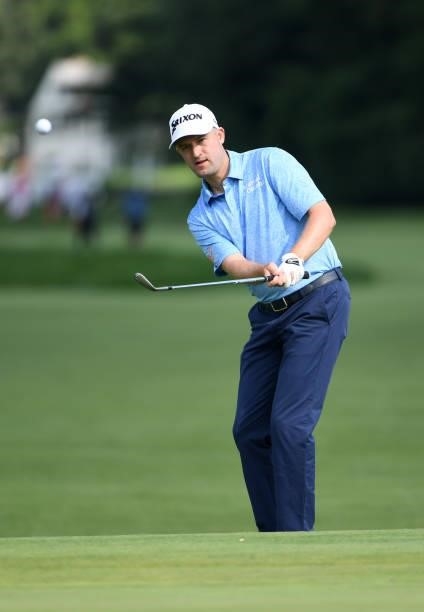 Russell Knox of Scotland chips onto the 17th green during the third round of the Rocket Mortgage Classic on July 03, 2021 at the Detroit Golf Club in...