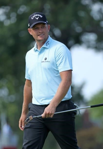 Tom Lewis of England reacts to his putt on the 15th green during the third round of the Rocket Mortgage Classic on July 03, 2021 at the Detroit Golf...
