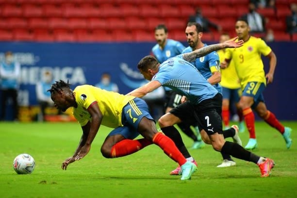 Duvan Zapata of Colombia falls down as he fights for the ball against Jose Gimenez of Uruguay during a quarter-final match of Copa America Brazil...
