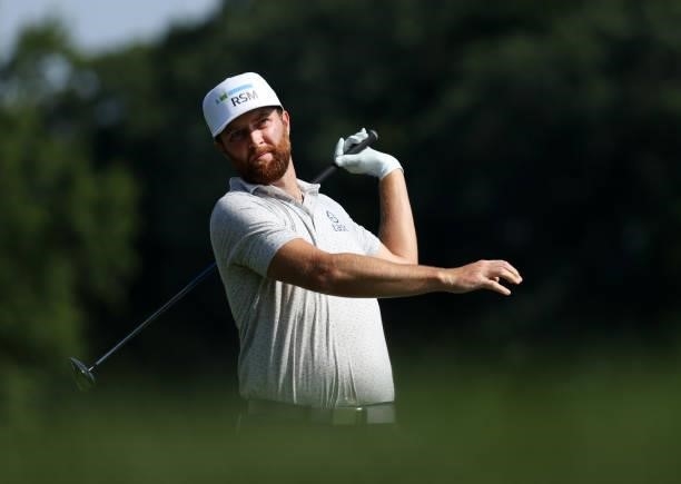 Chris Kirk plays his shot on the 14th hole during the third round of the Rocket Mortgage Classic on July 03, 2021 at the Detroit Golf Club in...