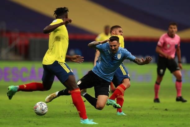 Rodrigo Bentancur of Uruguay falls down against Duvan Zapata of Colombia during a quarter-final match of Copa America Brazil 2021 between Colombia...