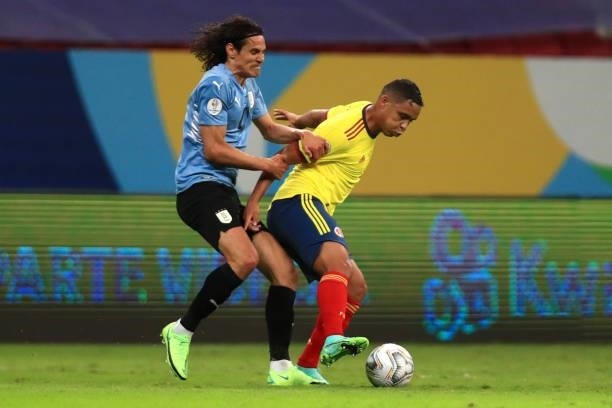 Luis Muriel of Colombia fights for the ball with Edinson Cavani of Uruguay during a quarter-final match of Copa America Brazil 2021 between Colombia...