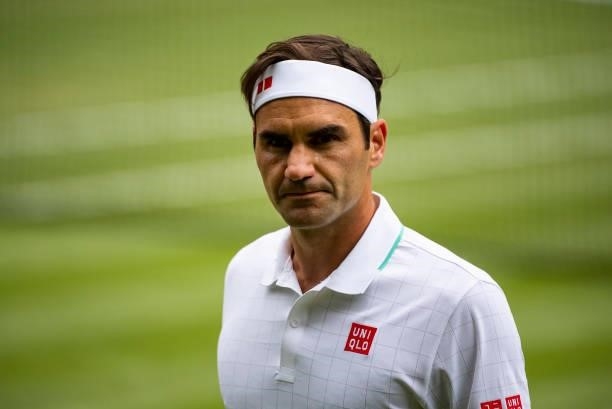 Roger Federer of Switzerland waits for the ball kids to throw him balls to serve against Cameron Norrie of Great Britain in the third round of the...