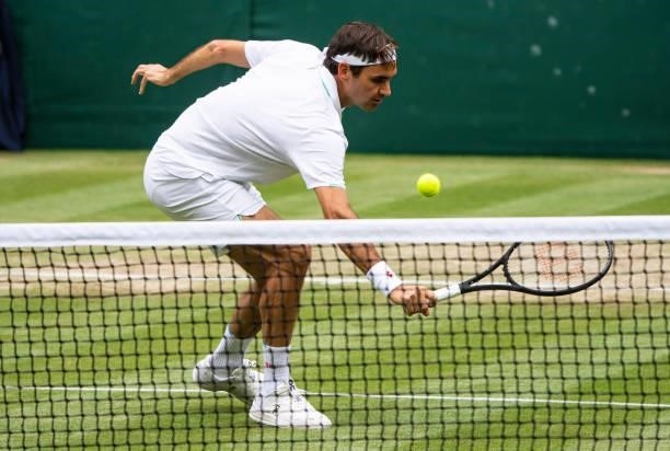 Roger Federer of Switzerland hits a backhand against Cameron Norrie of Great Britain in the third round of the gentlemen's singles during Day Six of...