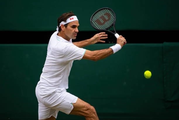Roger Federer of Switzerland hits a backhand against Cameron Norrie of Great Britain in the third round of the gentlemen's singles during Day Six of...