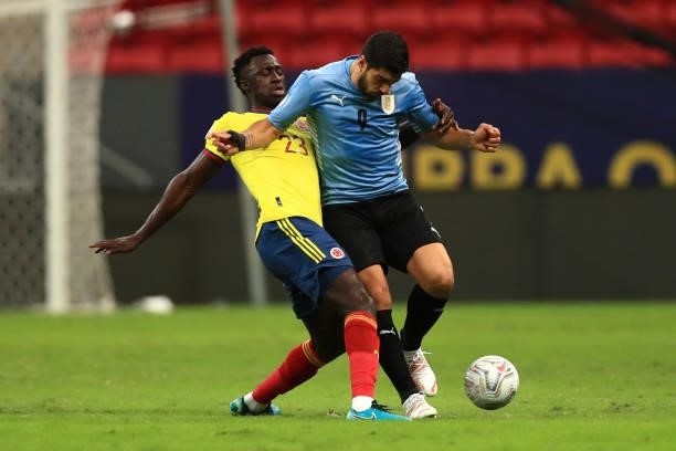 Luis Suarez of Uruguay fights for the ball with Davinson Sanchez of Colombia during a quarter-final match of Copa America Brazil 2021 between...