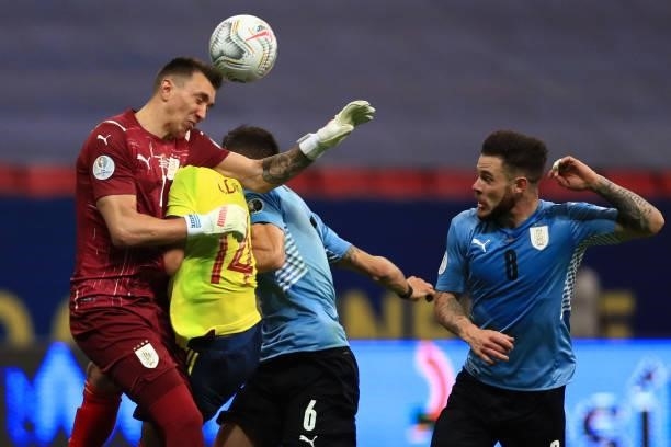 Luis Diaz of Colombia clashes with Fernando Muslera and Rodrigo Bentancur during a quarter-final match of Copa America Brazil 2021 between Colombia...