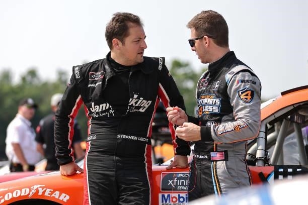 Stephen Leicht, driver of the Janiking Toyota, and Matt Jaskol, driver of the Auto Parts 4 Less Toyota, talk on the grid during the NASCAR Xfinity...