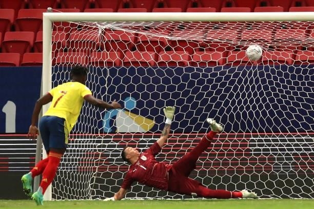 Duvan Zapata of Colombia scores his penalty kick against Fernando Muslera of Uruguay during a shootout after a quarter-final match of Copa America...