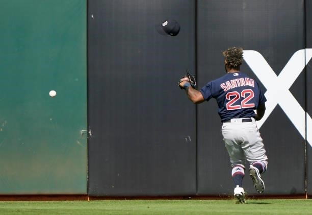 Danny Santana of the Boston Red Sox loses hit hat as the ball goes over hits head for an RBI triple off the bat of Seth Brown of the Oakland...