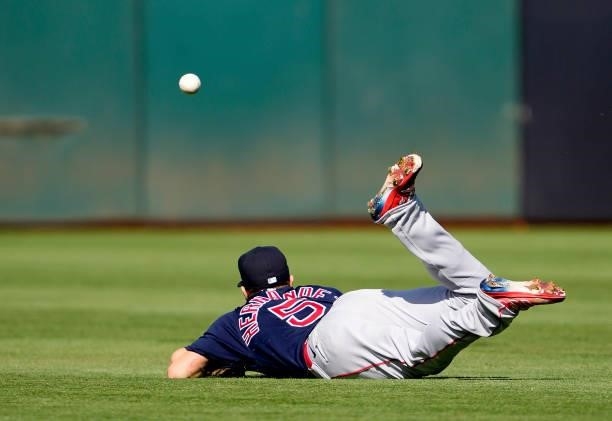 Enrique Hernandez of the Boston Red Sox dives for a ball that falls for a base hit off the bat of Sean Murphy of the Oakland Athletics in the bottom...