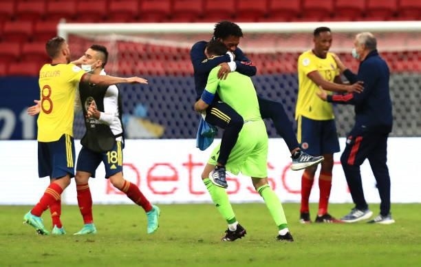 David Ospina of Colombia celebrates with teammate Juan Cuadrado of Colombia after winning in a penalty shootout after a quarter-final match of Copa...
