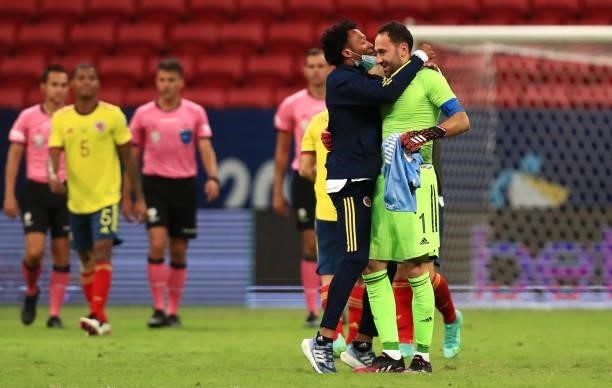 David Ospina of Colombia celebrates with teammate Juan Cuadrado after winning in a penalty shootout after a quarter-final match of Copa America...