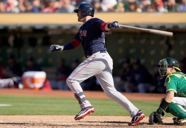 Martinez of the Boston Red Sox hits an RBI single that scored Enrique Hernandez against the Oakland Athletics in the top of the fifth inning at...