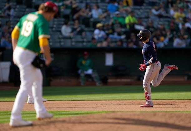 Enrique Hernandez of the Boston Red Sox trots around the bases after hitting a solo home run off of Cole Irvin of the Oakland Athletics in the top of...