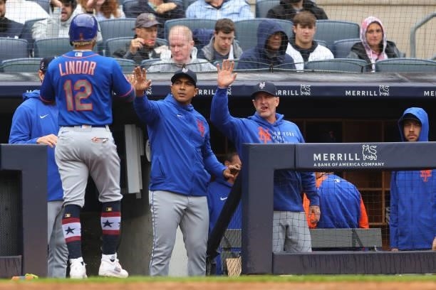 Francisco Lindor of the New York Mets is congratulated by manager Luis Rojas and bench coach Dave Jauss during a game against the New York Yankees at...