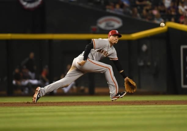 Wilmer Flores of the San Francisco Giants cannot make a diving play on an RBI single by Asdrubal Cabrera of the Arizona Diamondbacks during the...