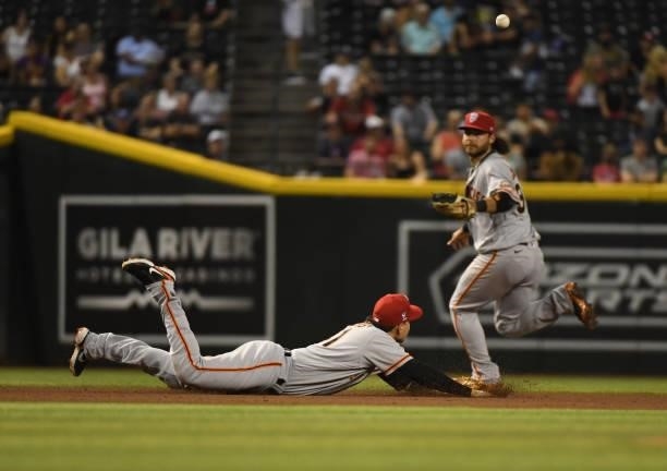 Wilmer Flores of the San Francisco Giants cannot make a diving play on an RBI single by Asdrubal Cabrera of the Arizona Diamondbacks during the...