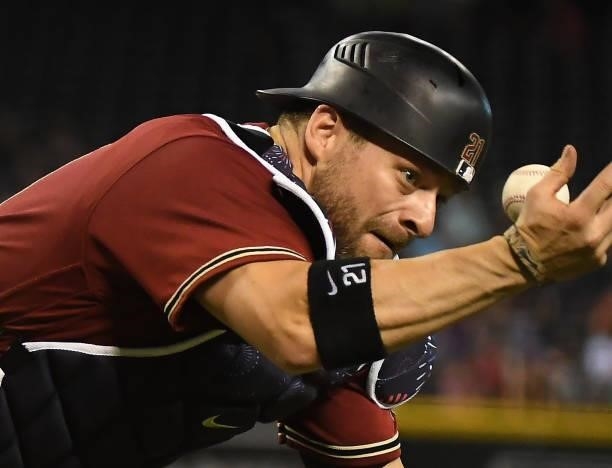 Stephen Vogt of the Arizona Diamondbacks cannot make a play on a popped up bunt attempt by Steven Duggar of the San Francisco Giants during the...