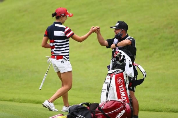 Chae-Young Yoon of South Korea fist bumps with her caddie after the birdie on the 1st green during the final round of the Shiseido Ladies Open at...
