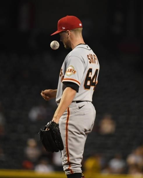 James Sherfy of the San Francisco Giants tosses the ball in the air after giving up a home run to Pavin Smith of the Arizona Diamondbacks at Chase...