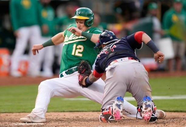 Christian Vazquez of the Boston Red Sox tags out Sean Murphy of the Oakland Athletics at home plate in the bottom of the tenth inning at RingCentral...