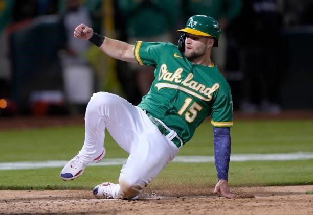 Seth Brown of the Oakland Athletics scores on a walk-off sacrifice fly from Tony Kemp against the Boston Red Sox in the bottom of the 12th inning at...