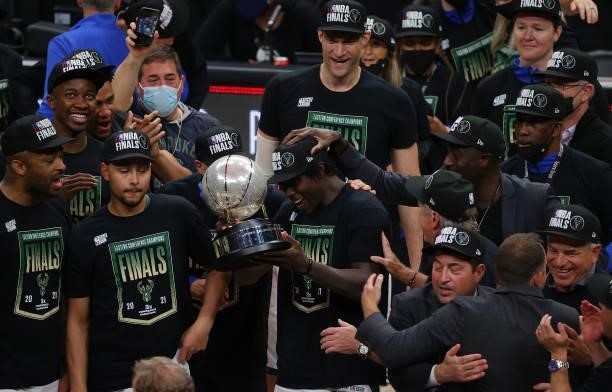 Jrue Holiday of the Milwaukee Bucks holds the Eastern Conference Finals trophy after the team's win a the Atlanta Hawks at State Farm Arena on July...