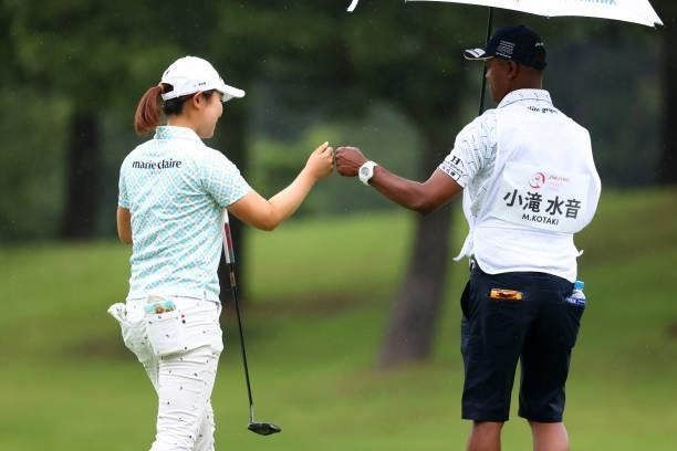 Mio Kotaki of Japan fist bumps with her cadie after the birdie on the 4th green during the final round of the Shiseido Ladies Open at Totsuka Country...