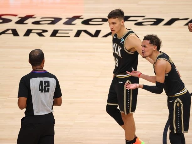 Trae Young of the Atlanta Hawks argues a technical foul with referee Eric Lewis during the second half in Game Six of the Eastern Conference Finals...